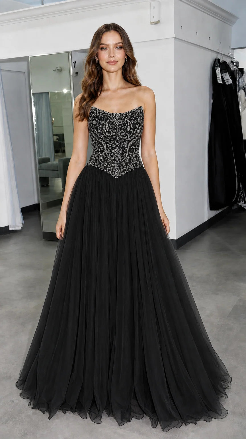 Front view of model wearing black beaded evening gown