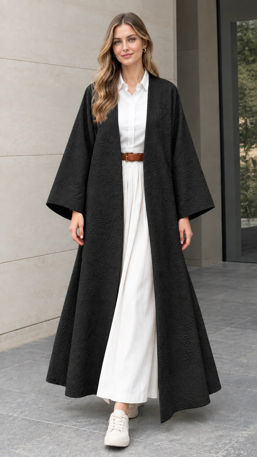 Front full-length view of woman wearing black textured jacquard open-front maxi duster