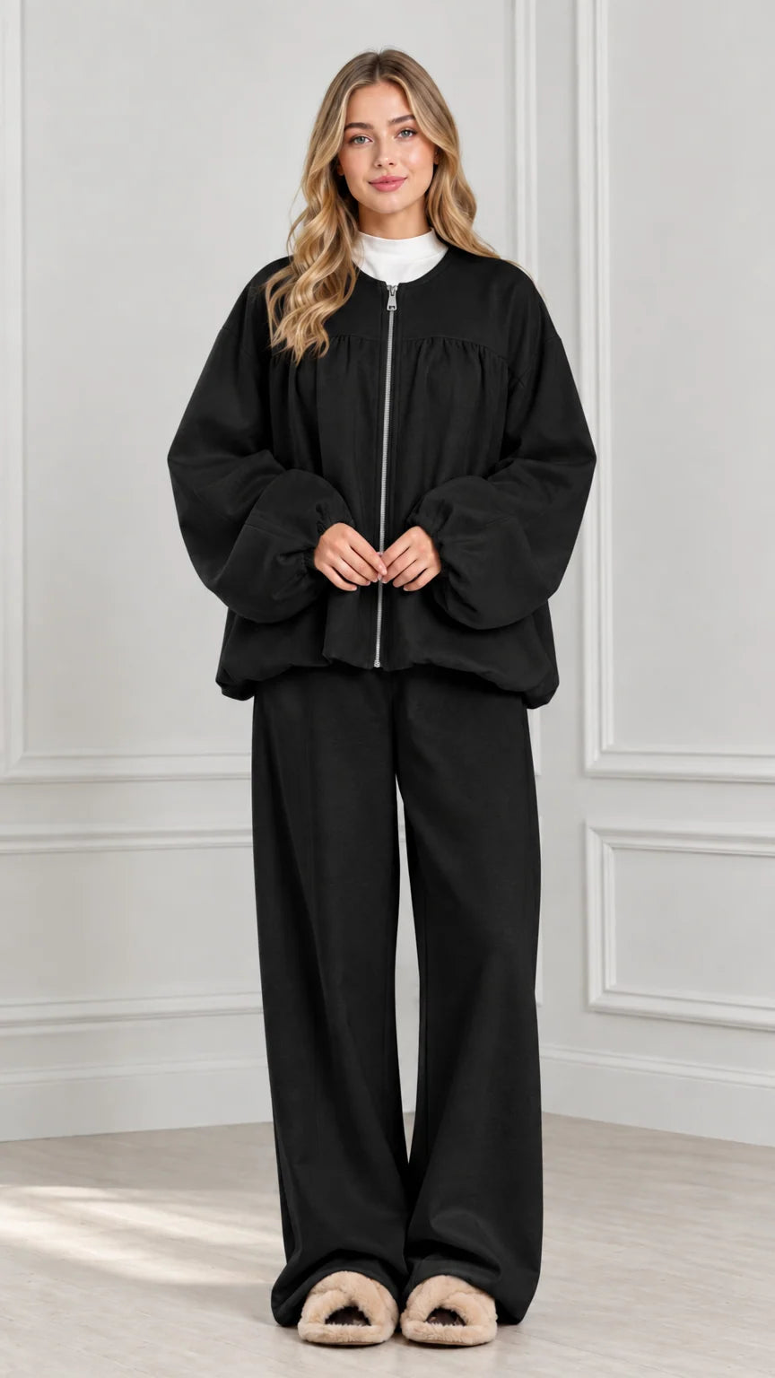 Full-body view of black two-piece zip jacket and wide-leg lounge set