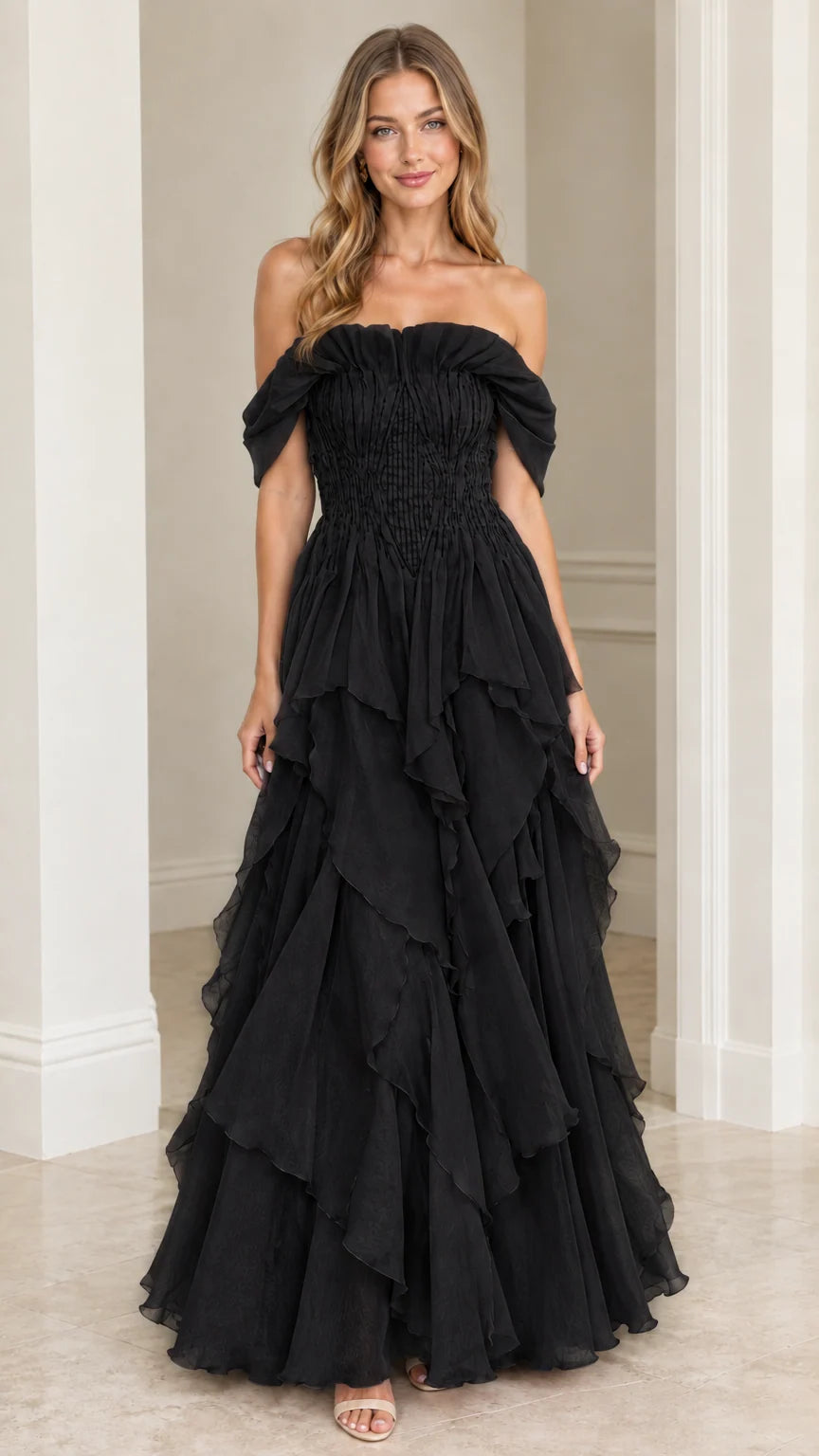 Front view of model wearing Black off-the-shoulder tiered ruffle maxi gown