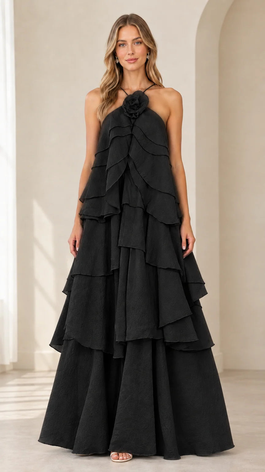 Full-length front view of model wearing Black tiered rosette halter maxi dress