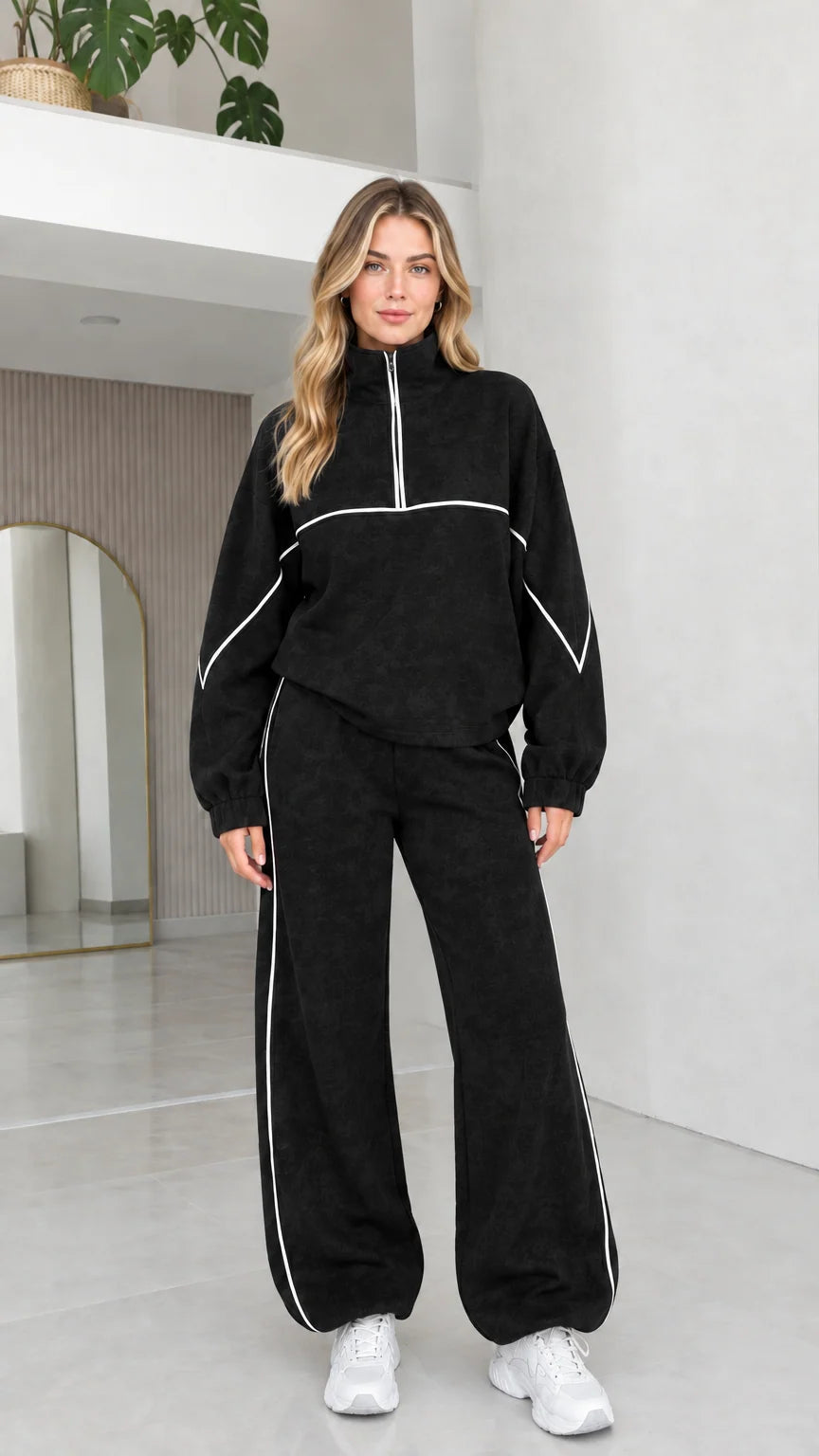 Black women's two-piece quarter zip fleece tracksuit set