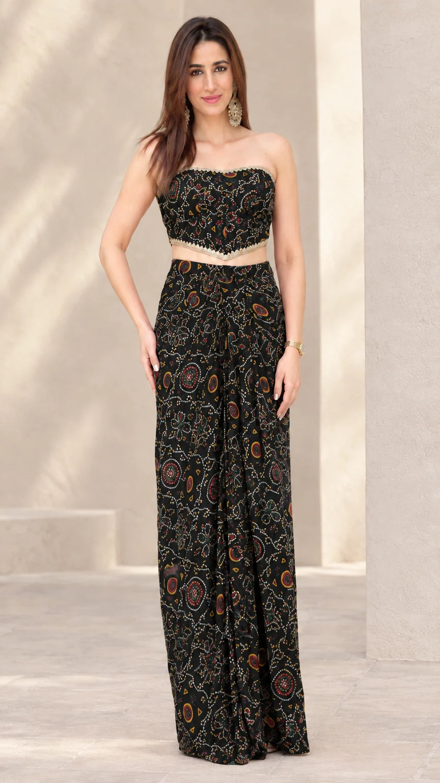 Woman wearing Black printed strapless crop top and draped skirt co-ord set