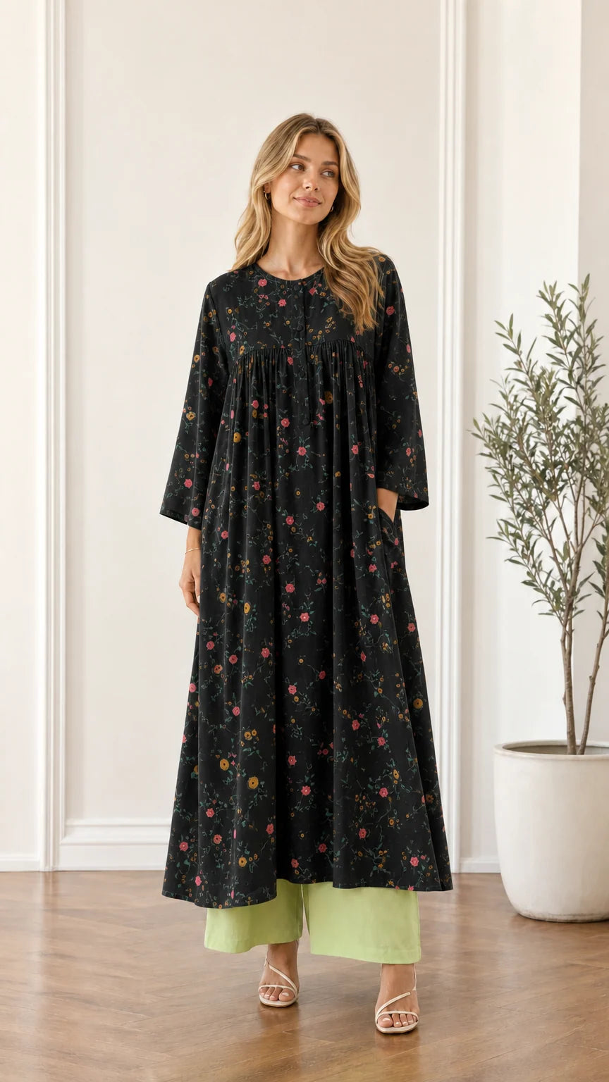 Front view of woman wearing black floral pleated maxi dress