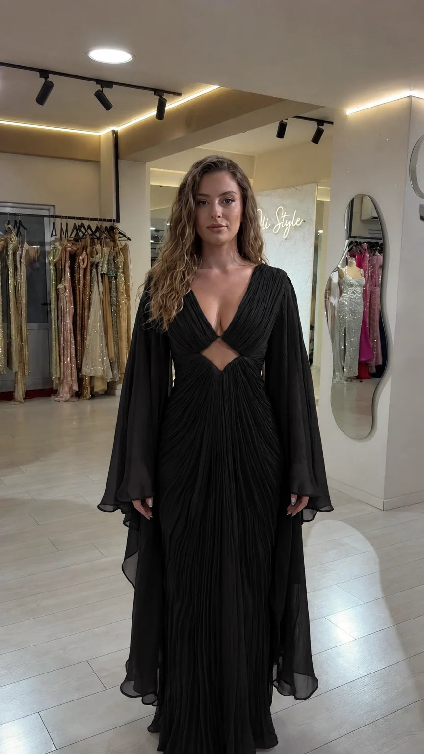 Black pleated deep V-neck maxi gown with dramatic cape sleeves