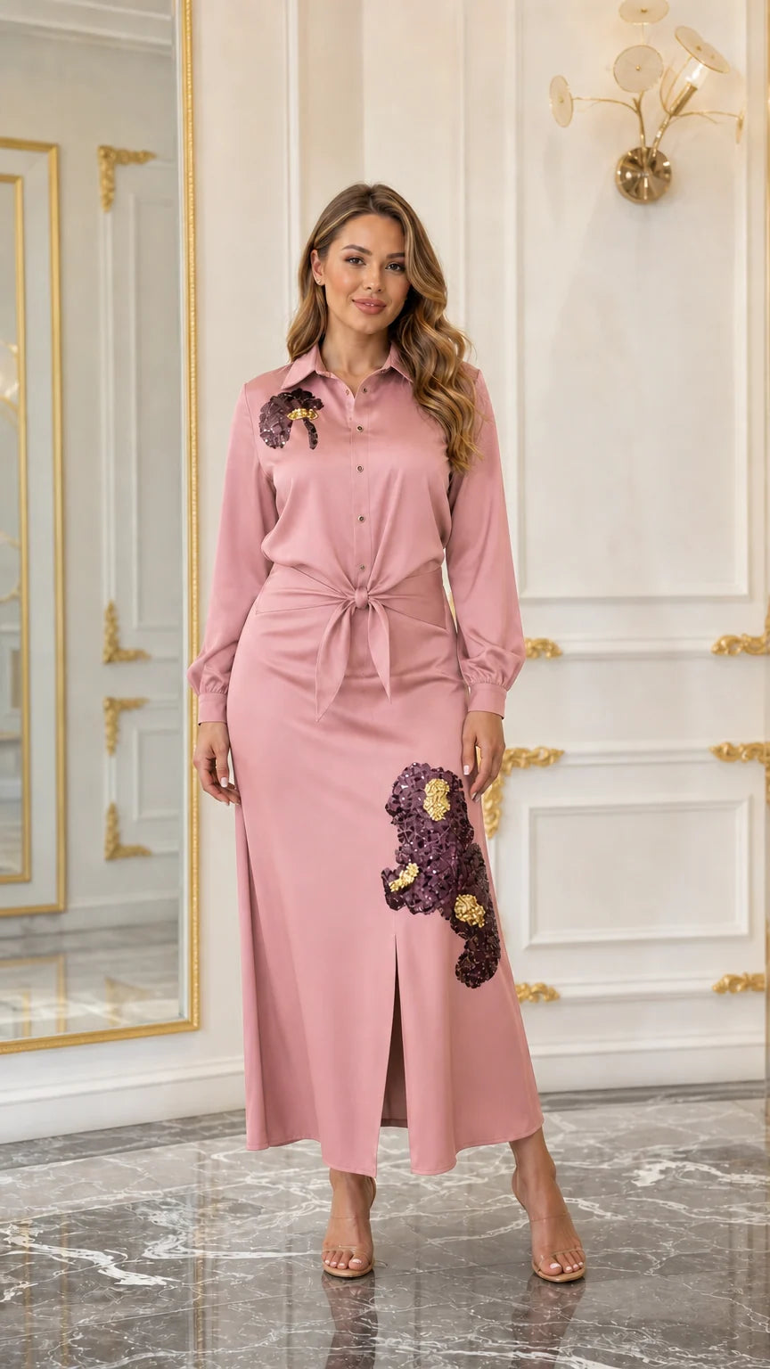 Woman wearing a dusty pink embellished maxi shirt dress with front slit