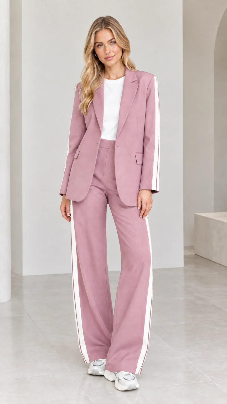 Model wearing dusty pink 2-piece blazer and wide-leg pants suit set with white side stripes