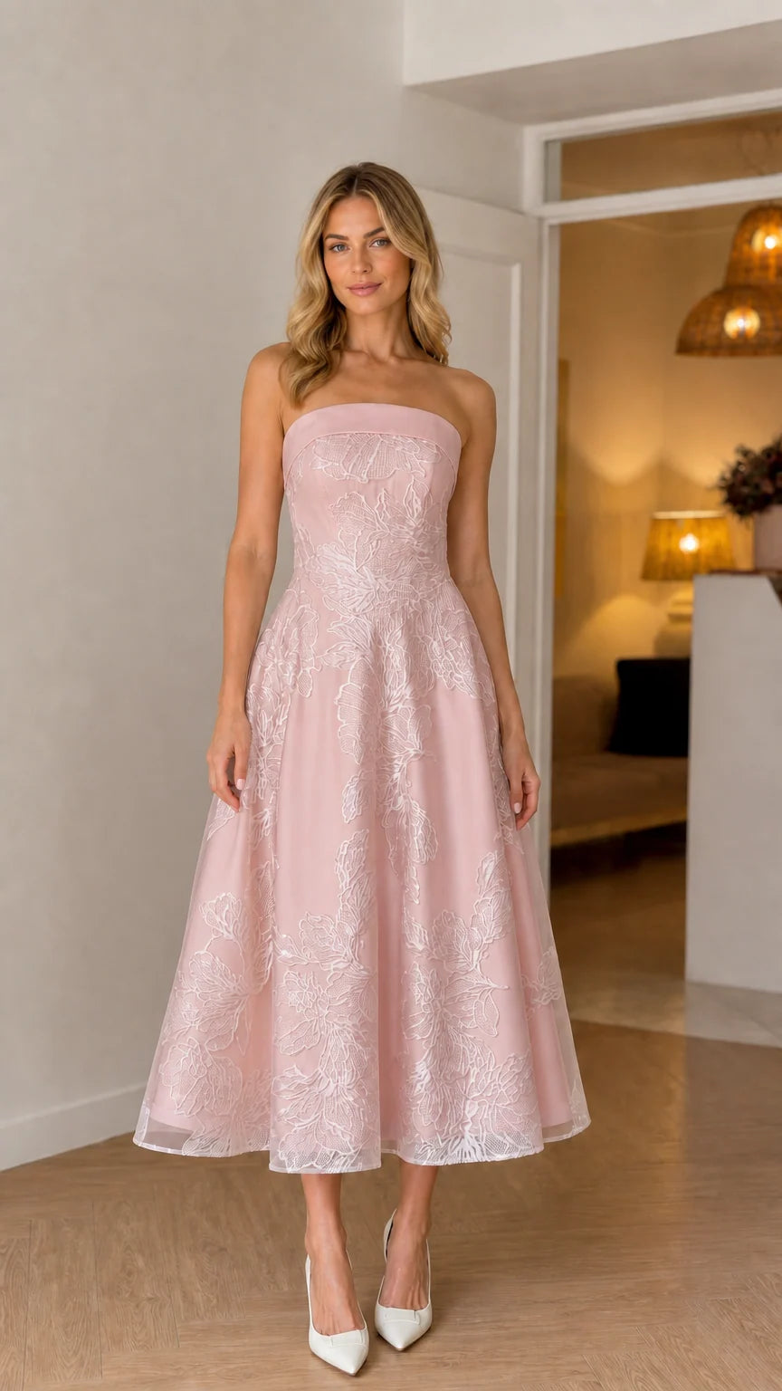 Model wearing soft pink strapless floral embroidered midi dress