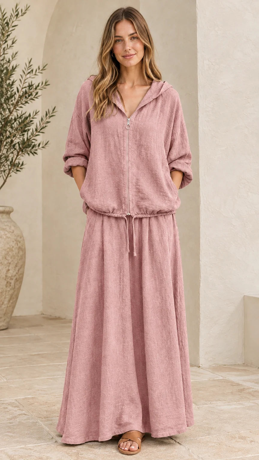 Front view of woman wearing dusty pink hooded top and matching maxi skirt set