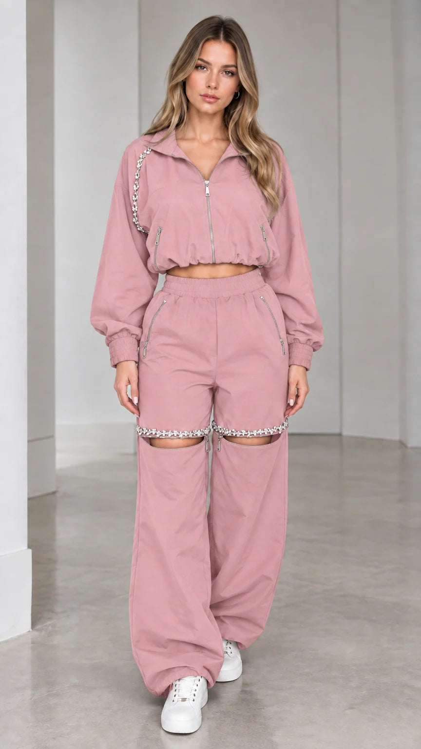 Model wearing dusty pink cropped zip jacket and rhinestone cut-out wide leg pants set