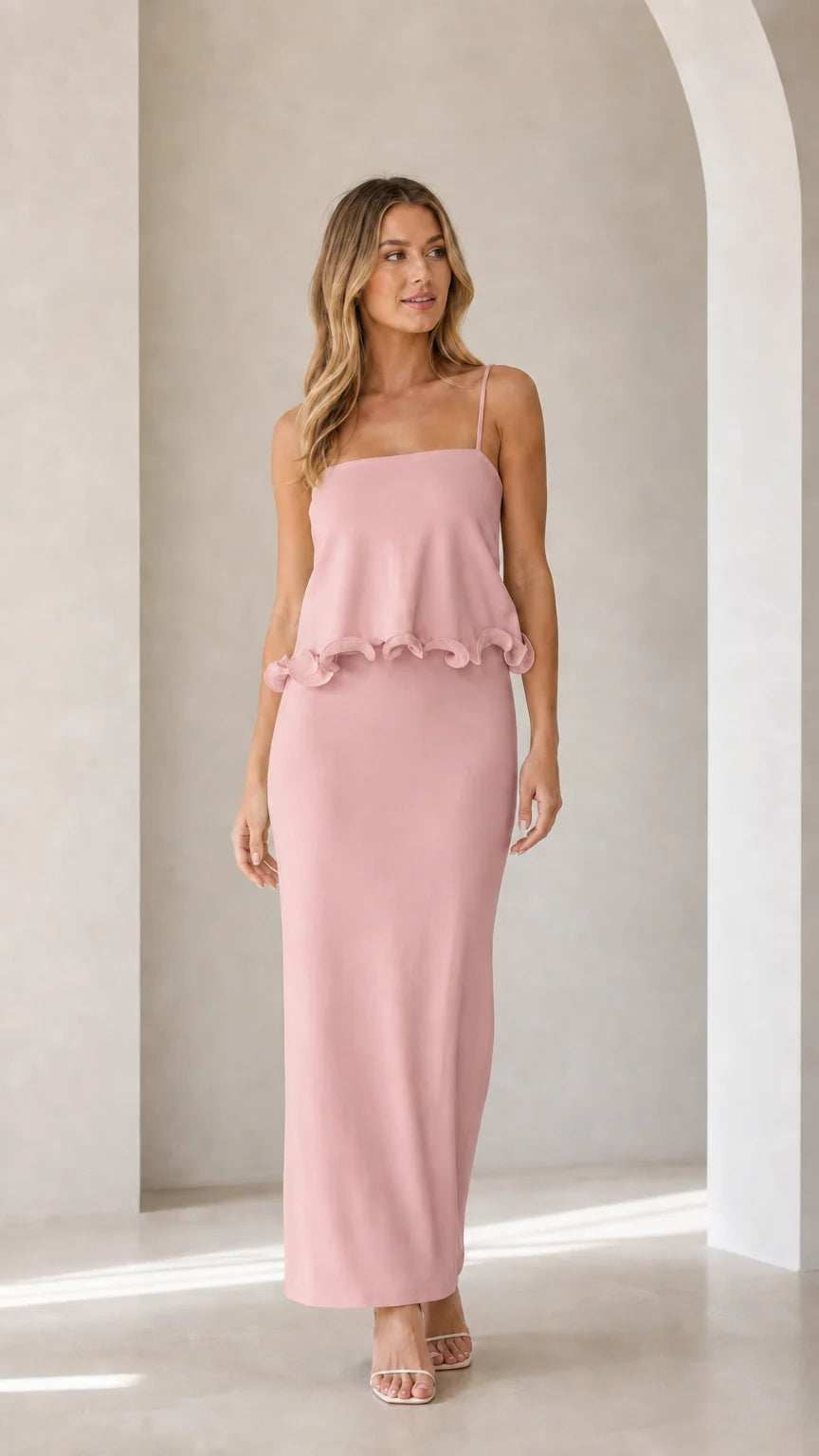 Model wearing pink sleeveless ruffle trim maxi camisole dress