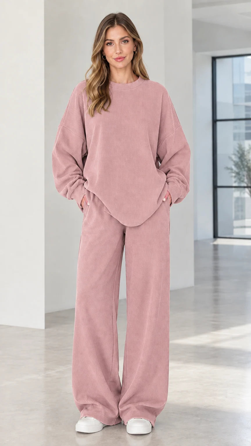 Woman wearing dusty pink two-piece ribbed matching lounge set with pockets