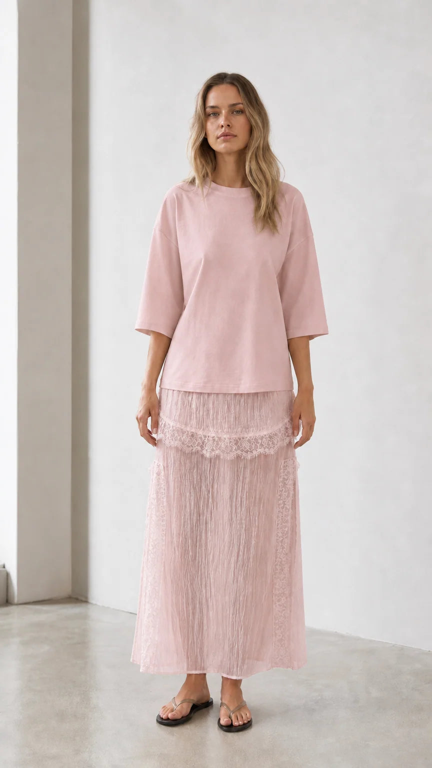 Front view of woman wearing pink relaxed tee and matching skirt set