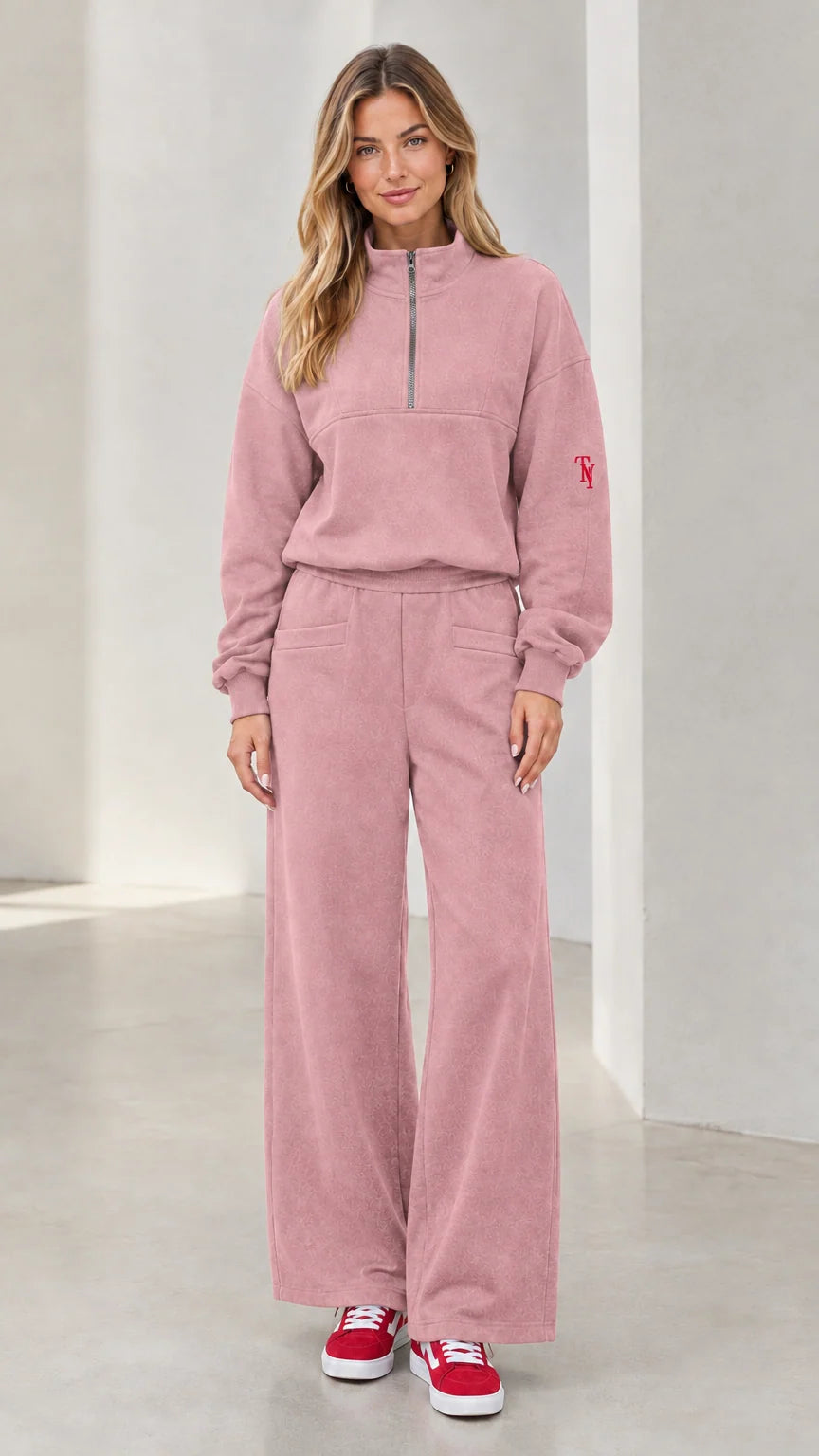 Front view of woman wearing dusty pink half-zip pullover and wide-leg lounge set