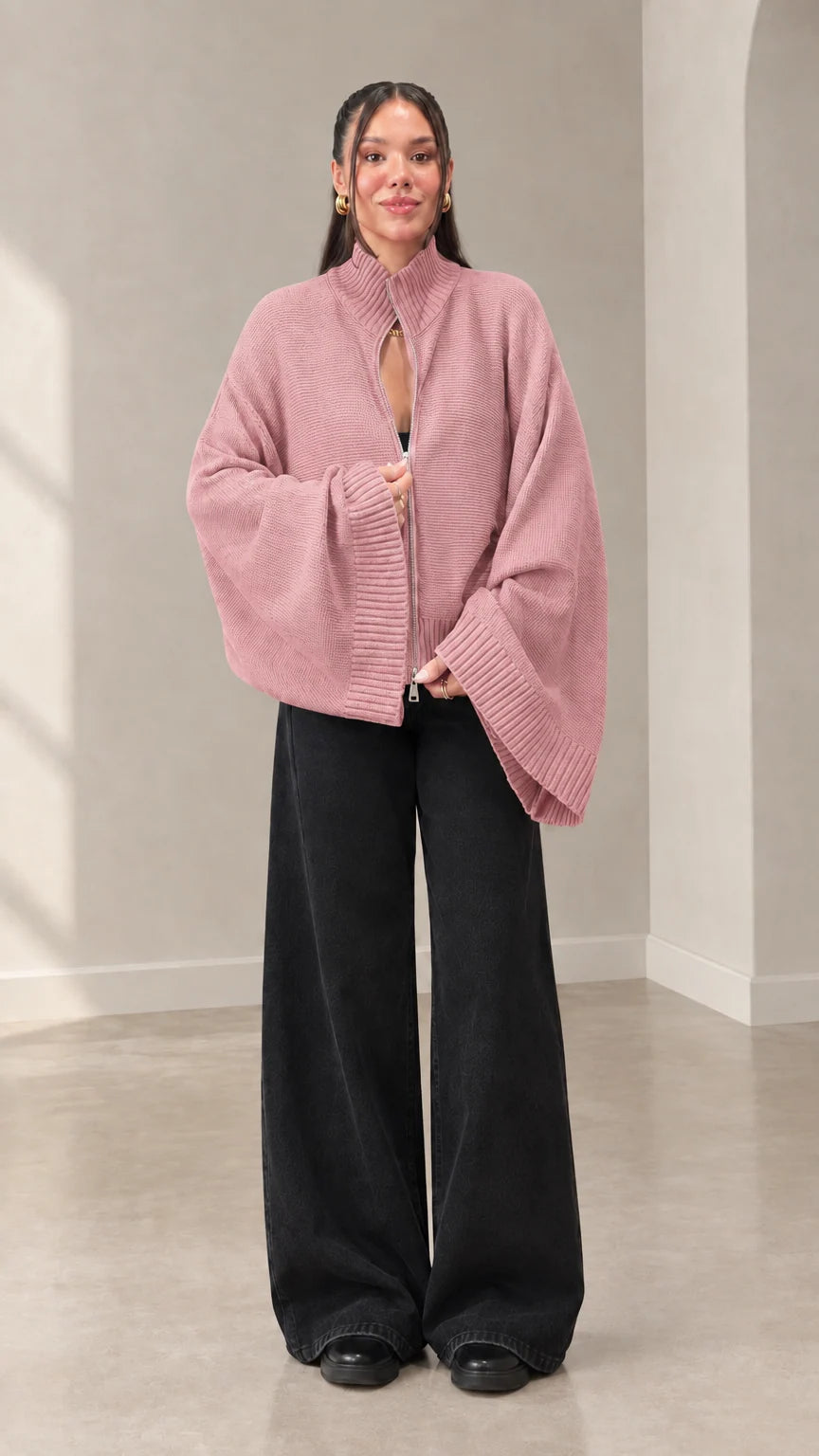 Woman wearing dusty pink zip-front flared sleeve knit sweater