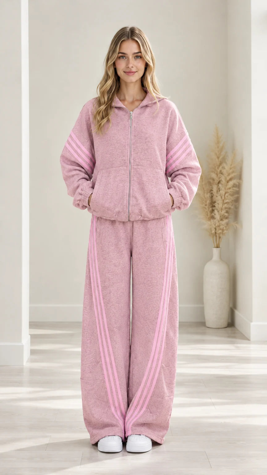 Woman modeling Dusty Pink two-piece zip-up tracksuit set with light pink stripes