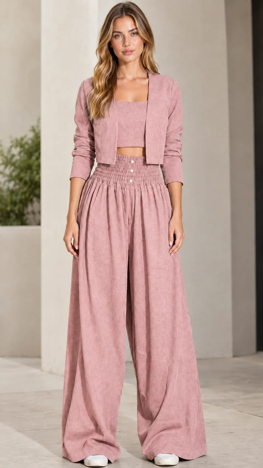 Front view of model wearing dusty pink 3-piece crop top, jacket, and wide-leg pants set