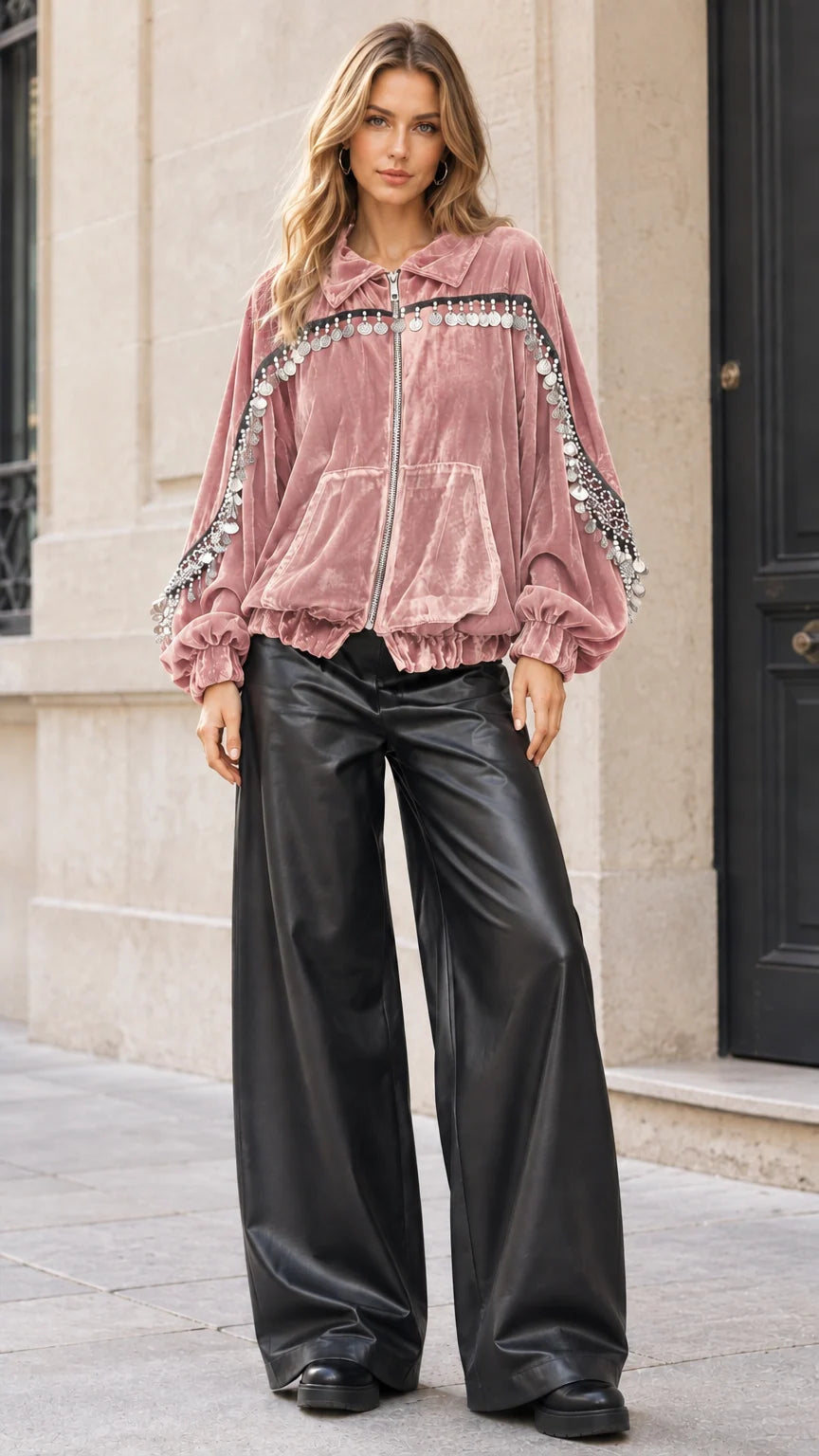 Model wearing dusty pink velvet zip-up jacket with coin fringe trims