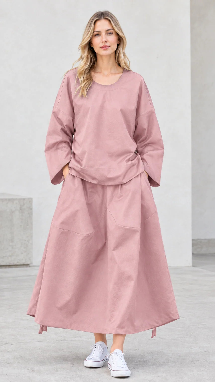 Front view of model wearing dusty pink long sleeve top and maxi skirt set