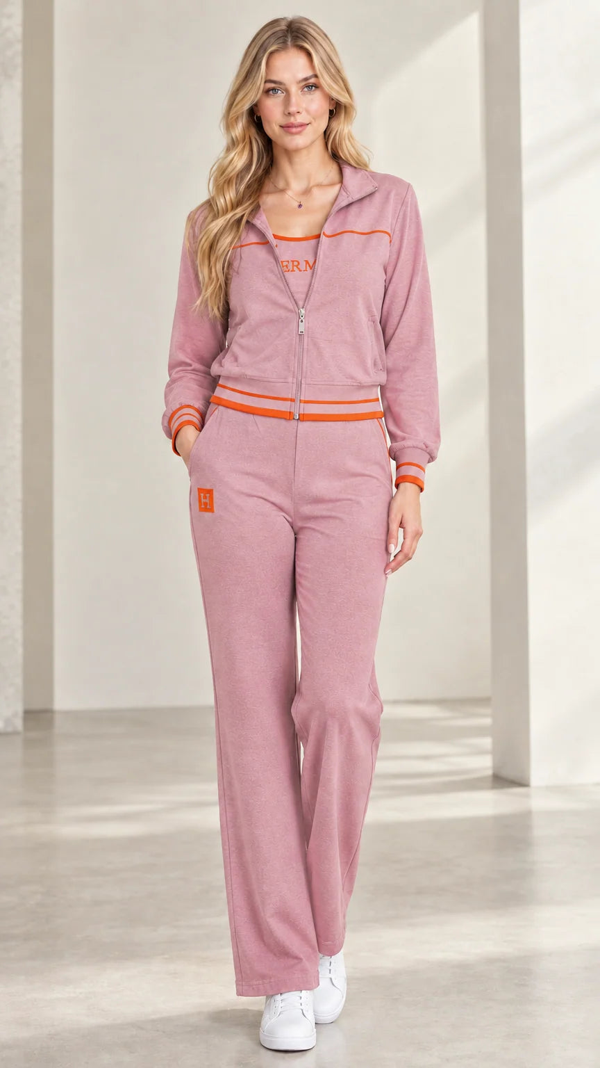 Woman wearing dusty pink two-piece zip-up tracksuit set