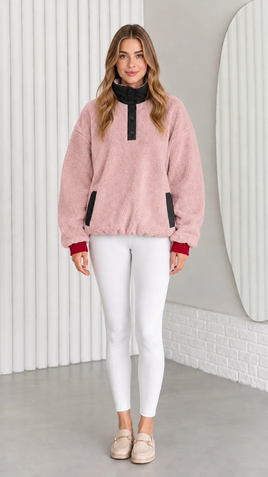Model wearing dusty pink sherpa fleece pullover sweatshirt with black collar trim