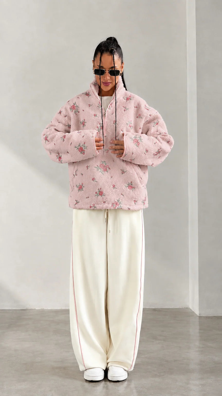 Front view of model wearing pink floral print half-zip fleece pullover