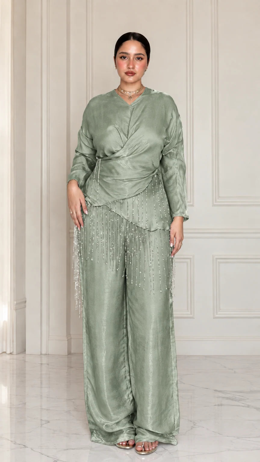 Full-length view of model wearing Sage Green satin draped two-piece set with beaded trim