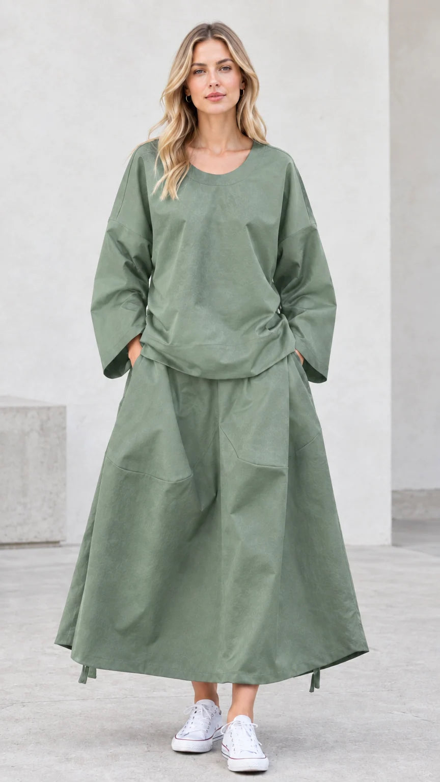 Front view of model wearing sage green relaxed two-piece skirt set