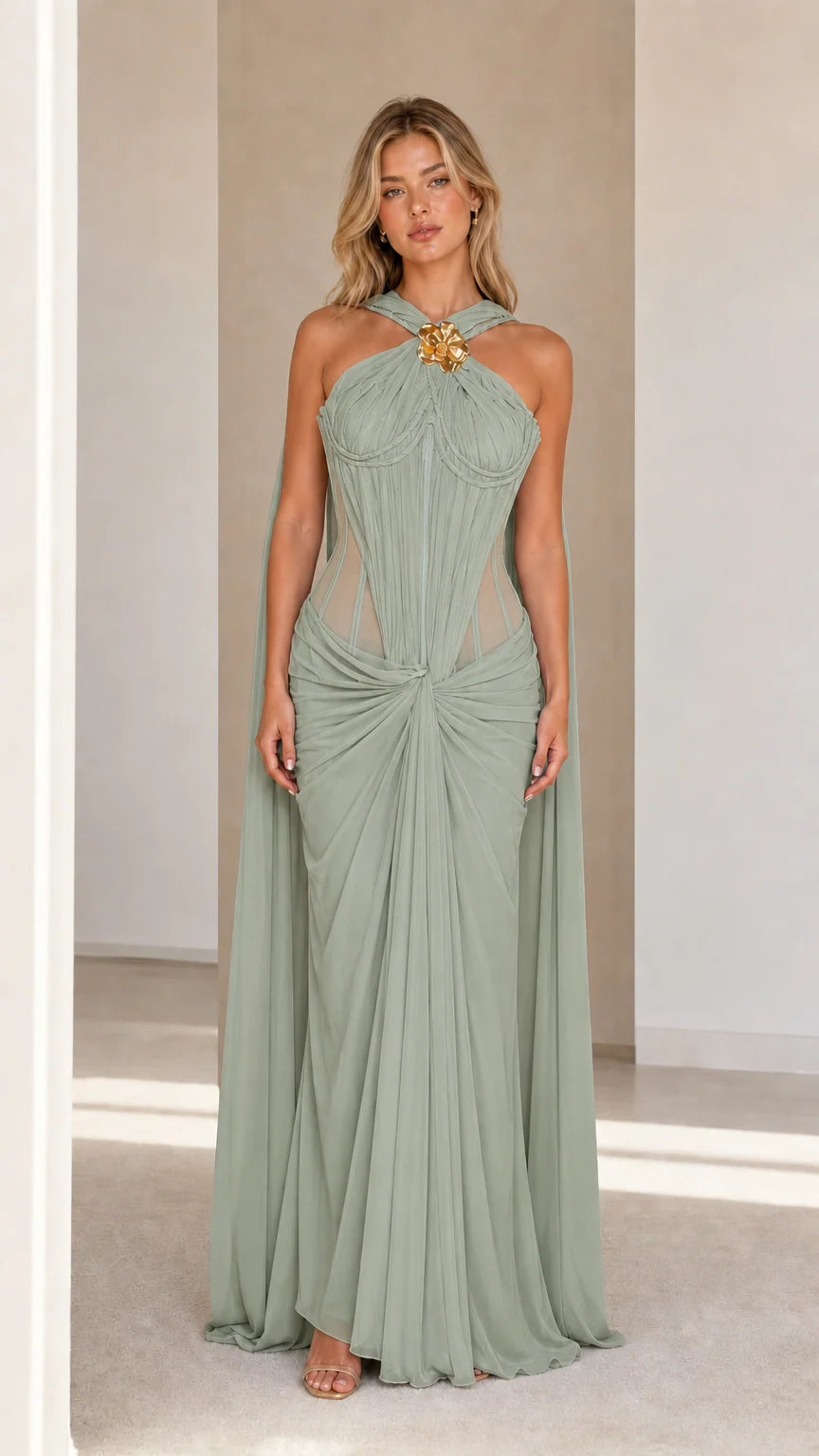 Model wearing sage green evening cape maxi dress
