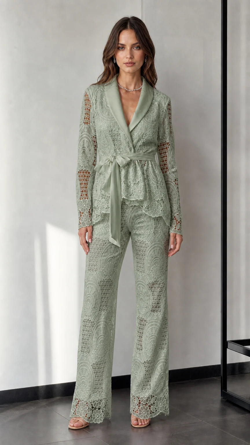 Woman wearing sage green lace blazer and trousers set