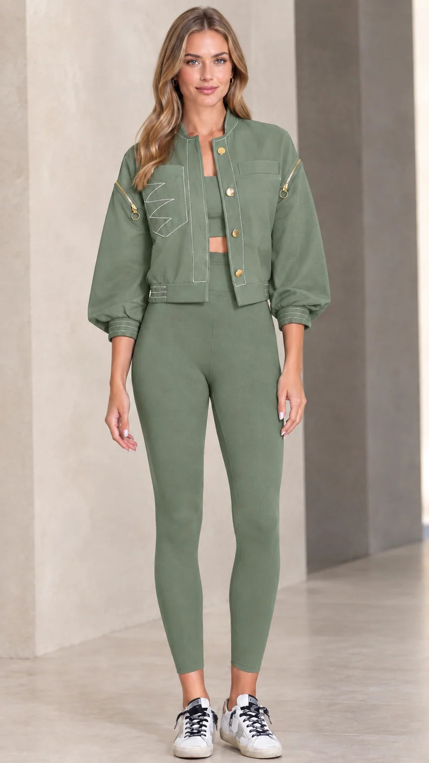 Model wearing sage green cropped utility jacket with contrast topstitching