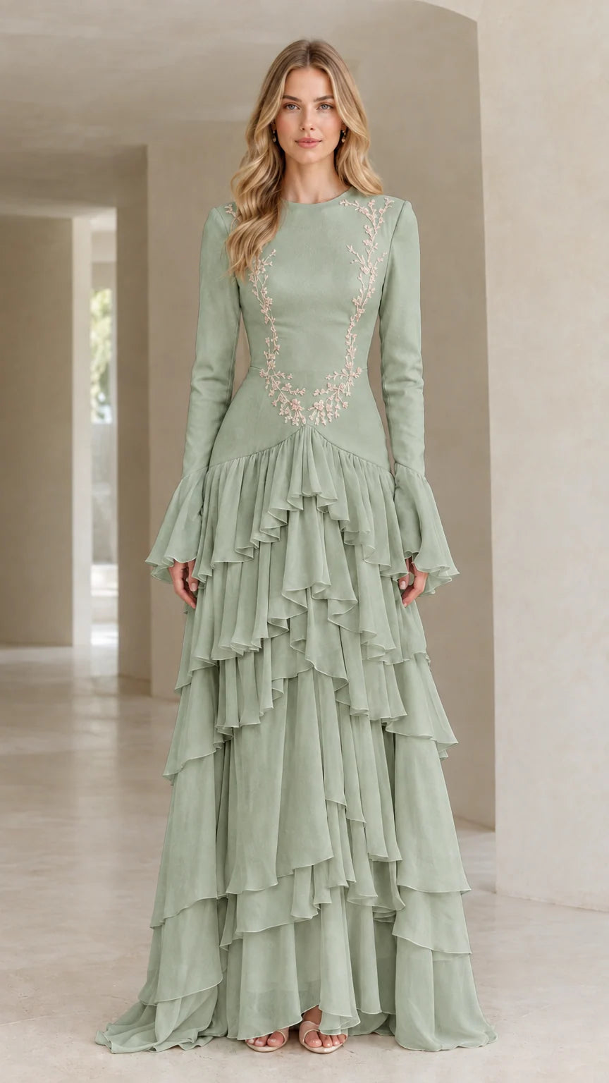 Front full view of woman wearing sage green embroidered tiered ruffle long sleeve evening gown