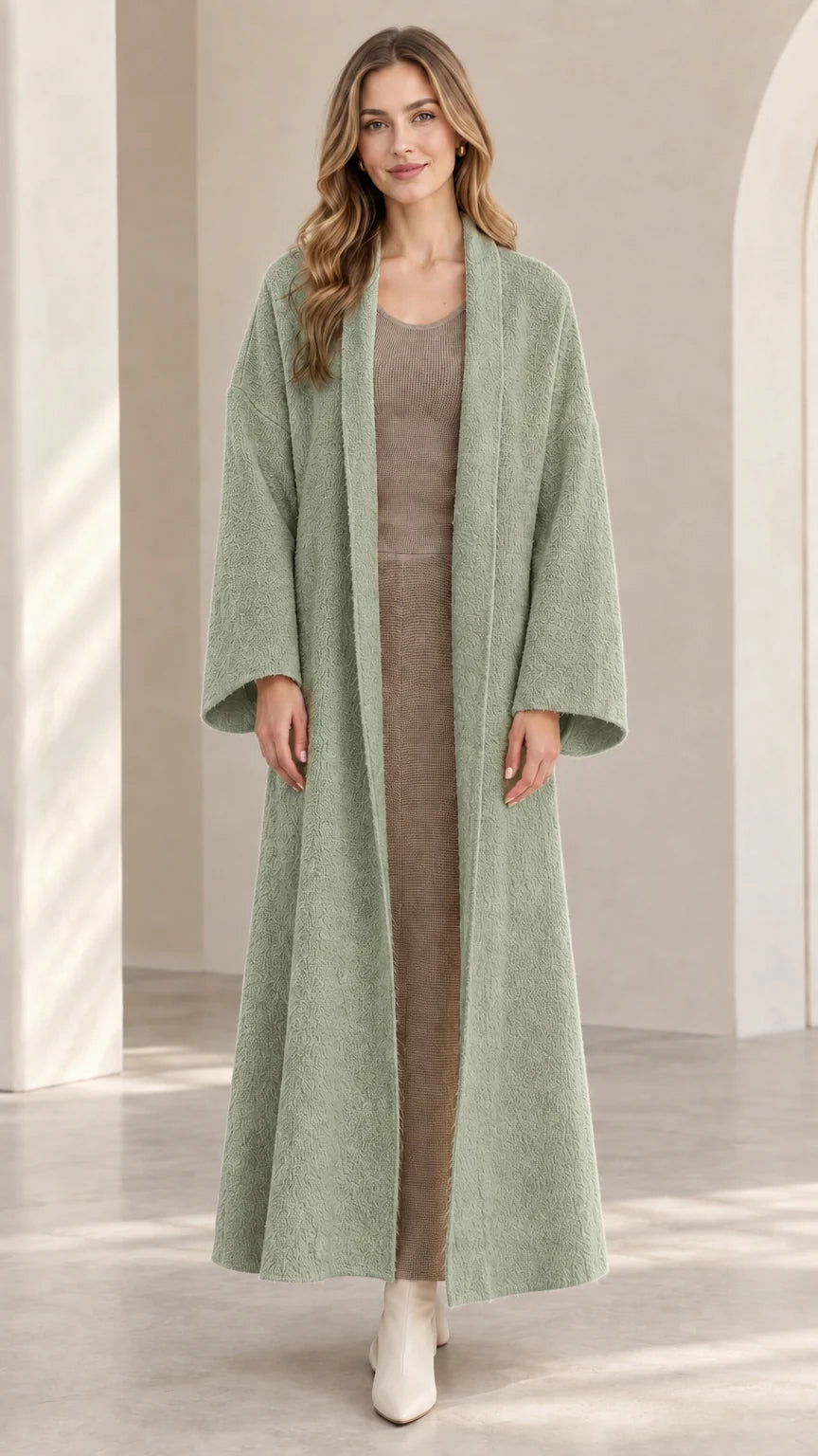 Front view of model wearing sage green textured longline open-front coat
