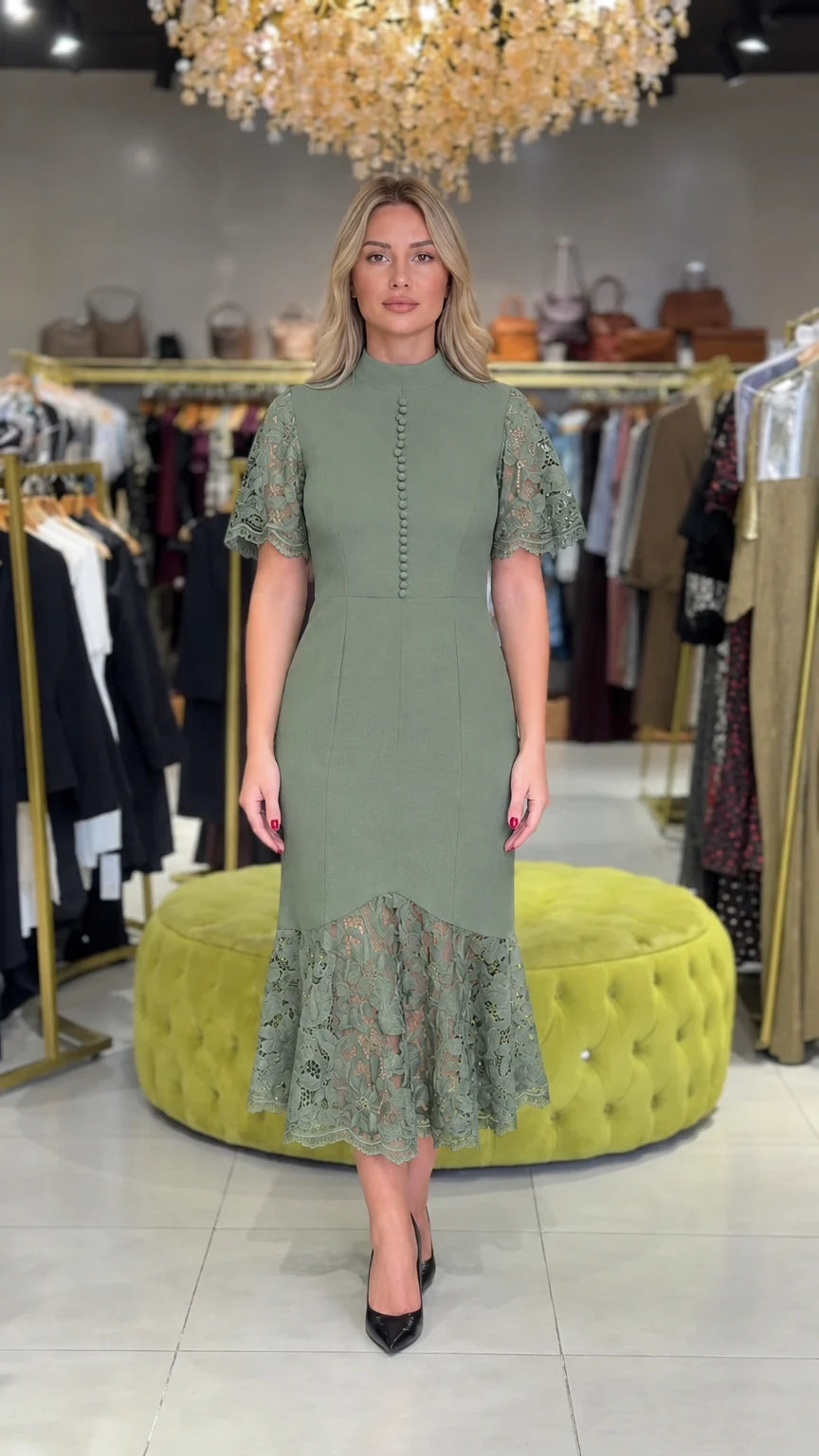 Model wearing sage green mock neck midi dress with floral lace accents