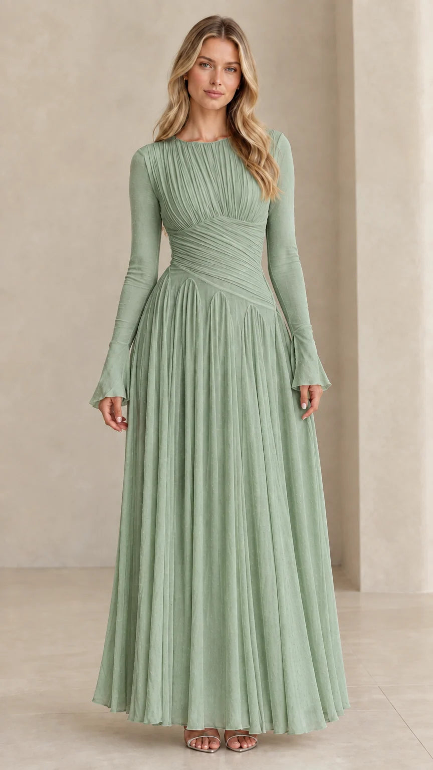 Model wearing sage green long sleeve pleated evening gown