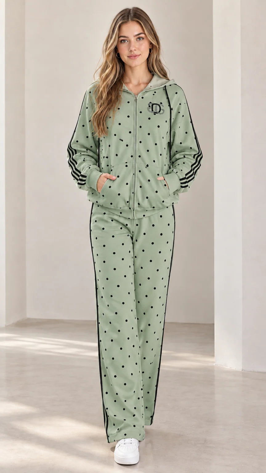 Model wearing sage green polka dot zip hoodie and matching sweatpants set
