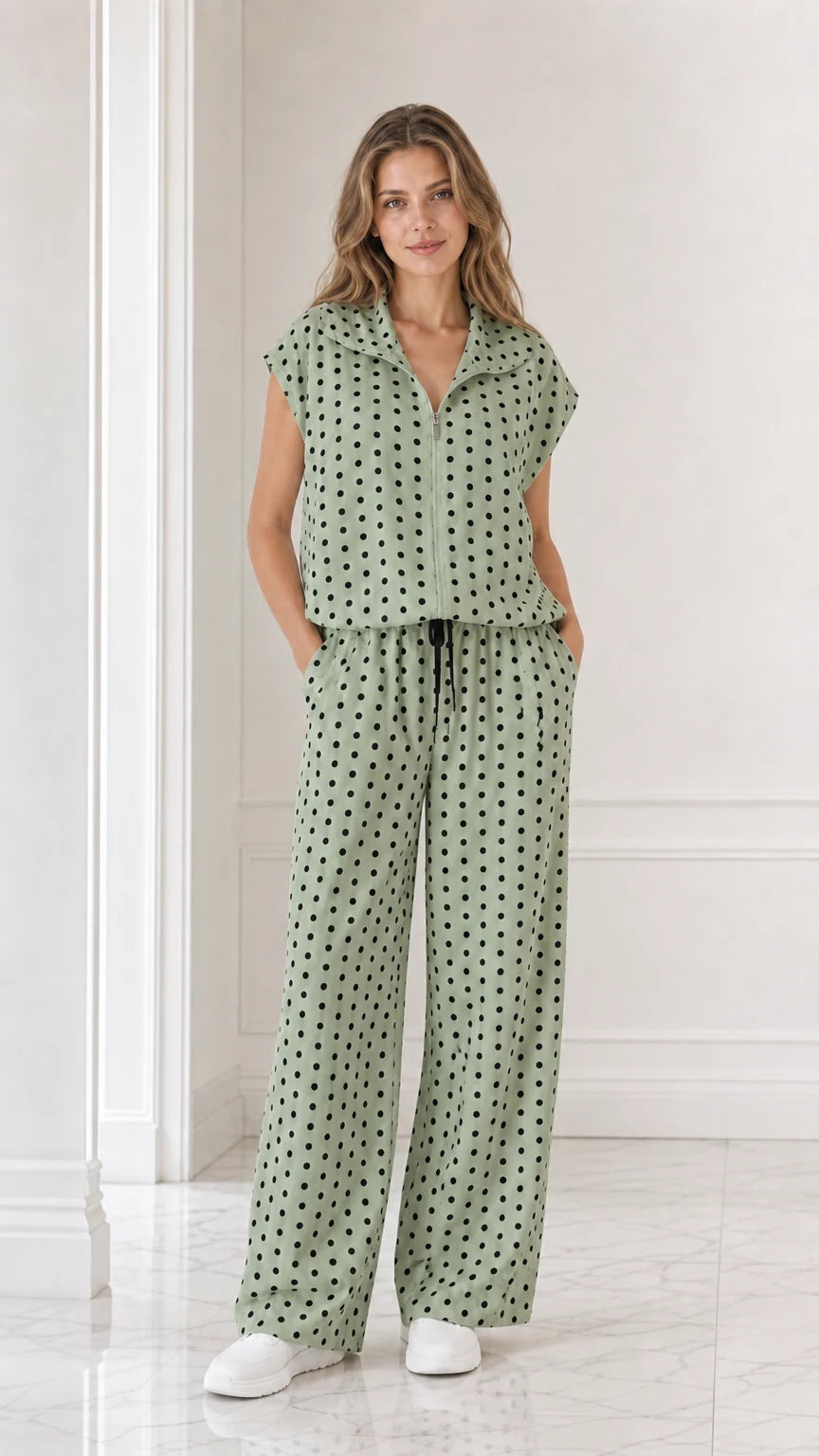 Model wearing sage green polka dot two-piece set with wide leg pants