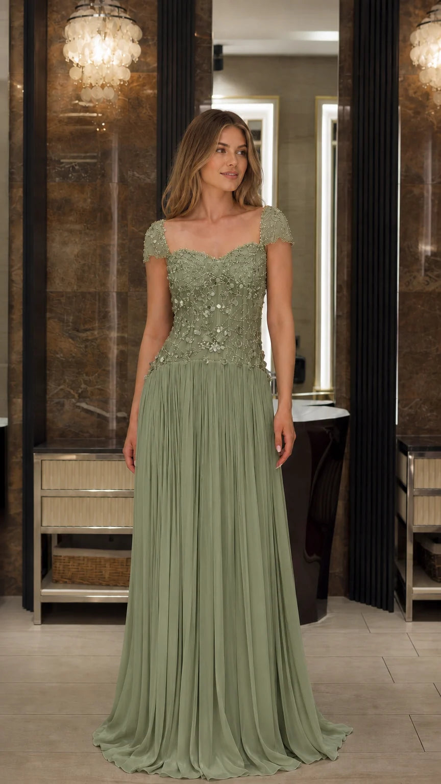 Front view of model wearing the Sage Green beaded cap sleeve pleated formal gown