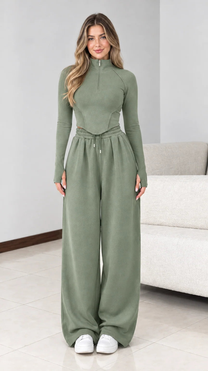 Front view of model wearing sage green half zip wide leg tracksuit