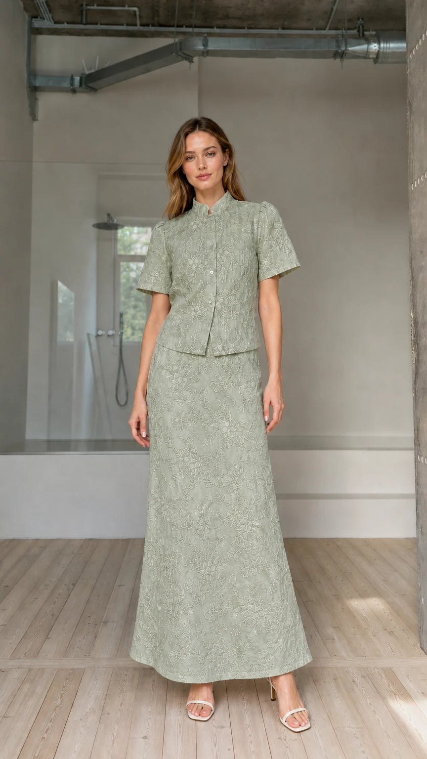 Model wearing sage green floral embroidered short-sleeve blouse and maxi skirt set