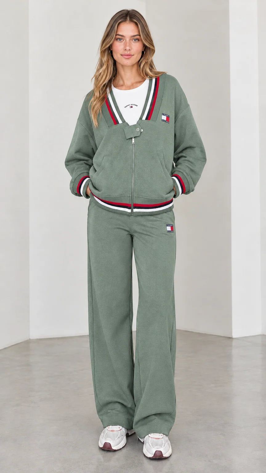 Front view of model wearing sage green varsity striped tracksuit set