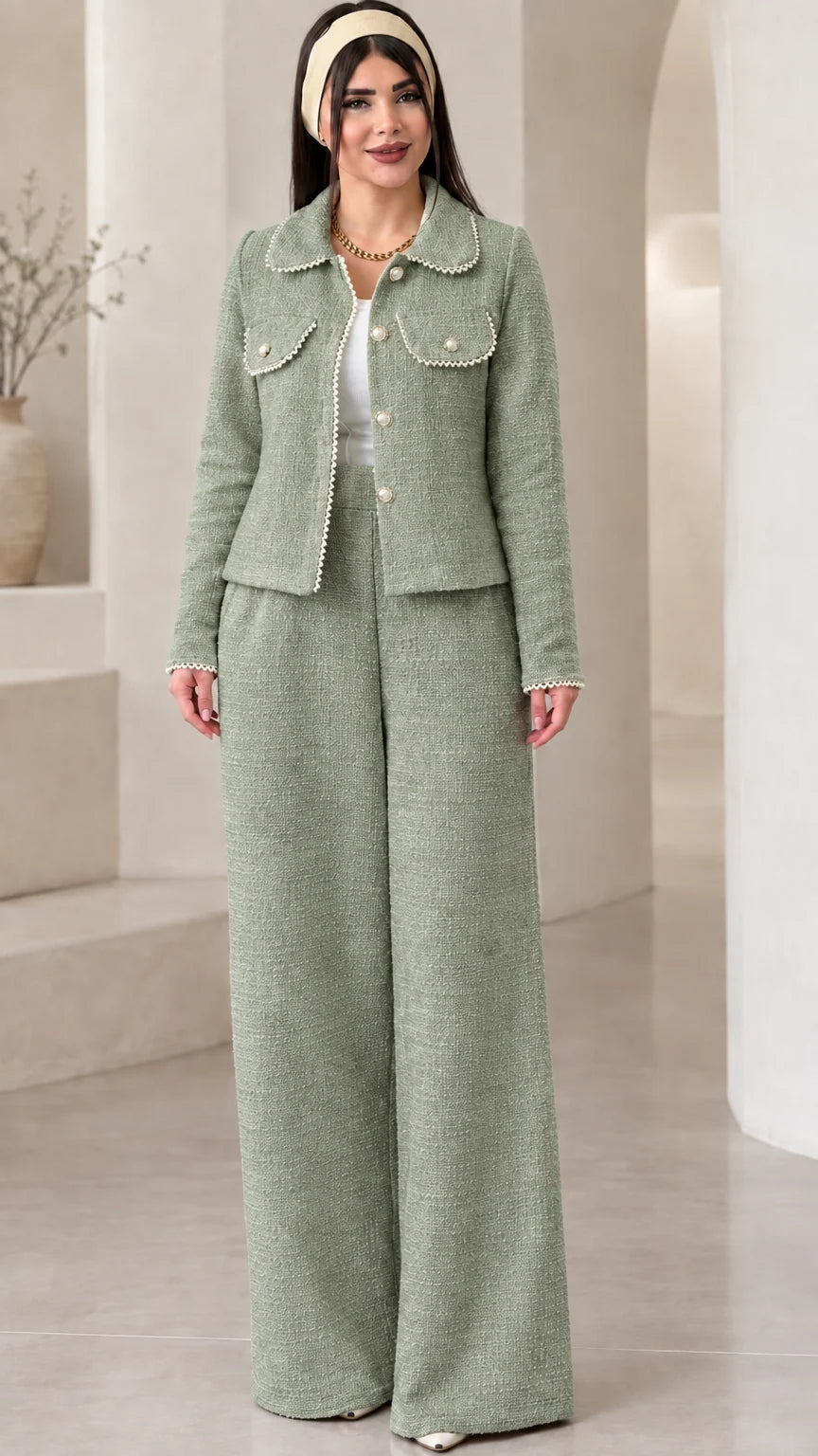 Front view of model wearing the sage green pearl-trimmed tweed jacket and trouser set