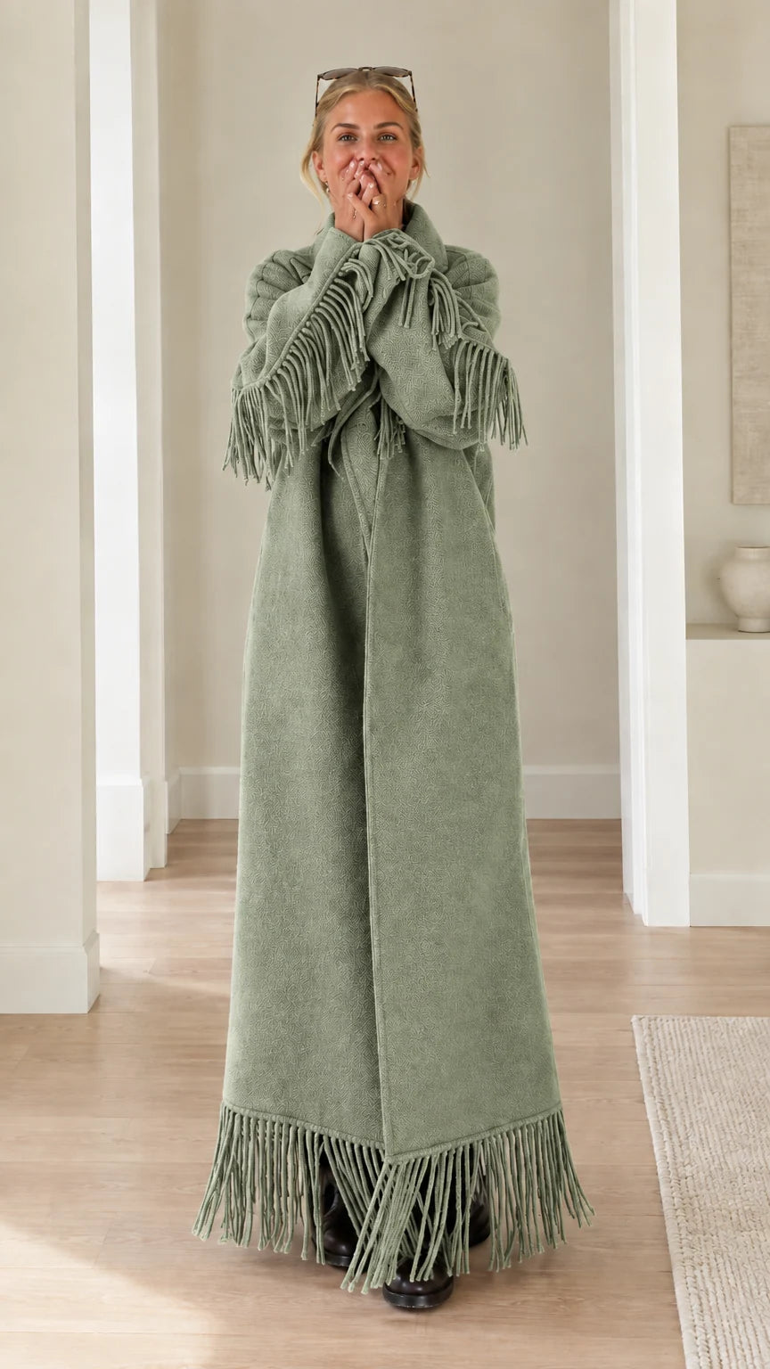 Full-length view of woman wearing sage green fringe trimmed maxi overcoat