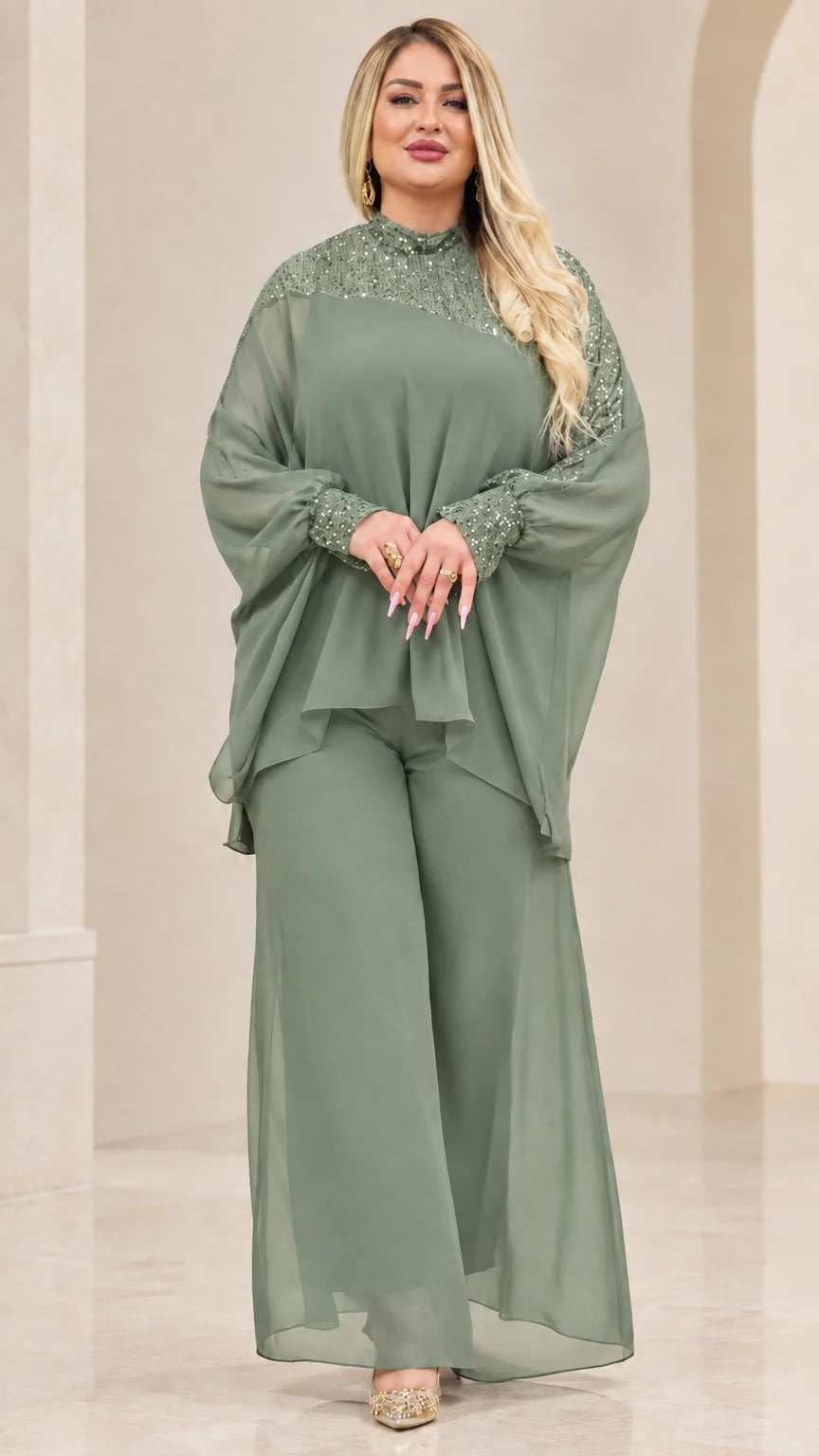 Front view of woman wearing Sage Green chiffon cape top and wide-leg pant set with sequin details