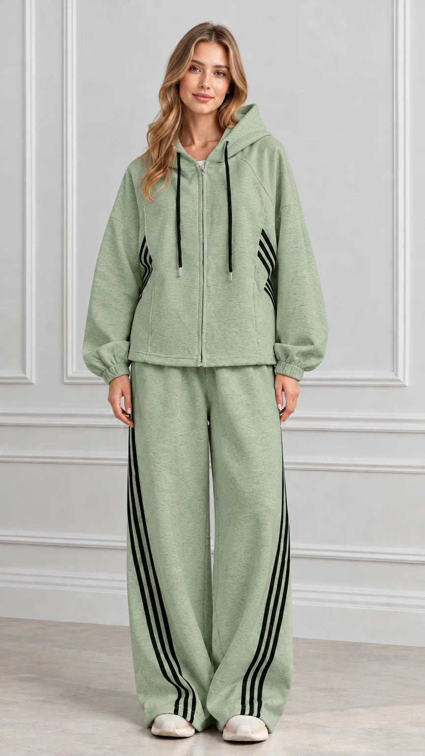 Front view of woman wearing Sage Green zip-up hoodie and wide-leg striped track set