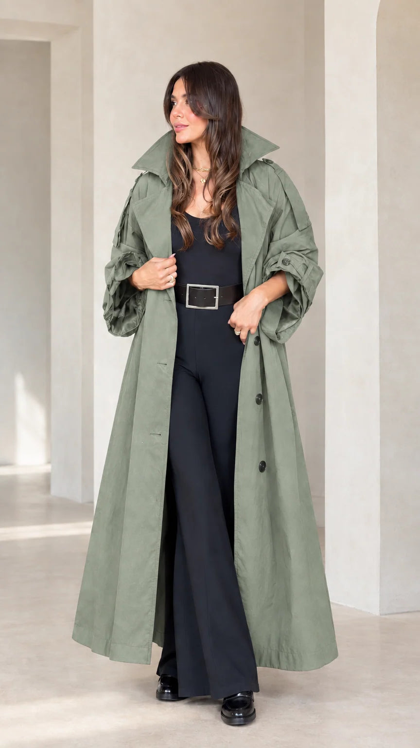 Front view of woman wearing sage green long maxi trench coat