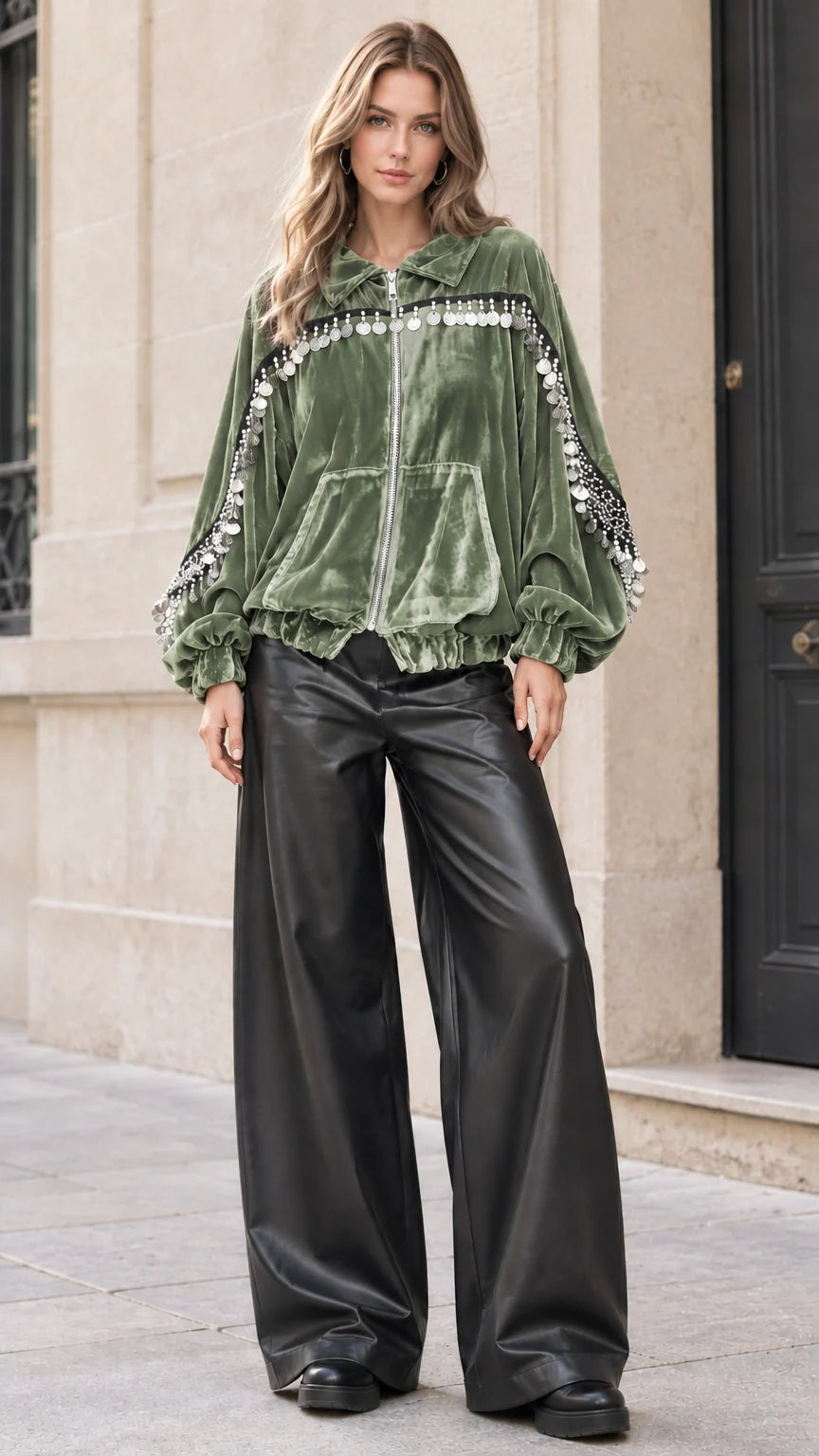 Model wearing sage green velvet bomber jacket with metallic fringe