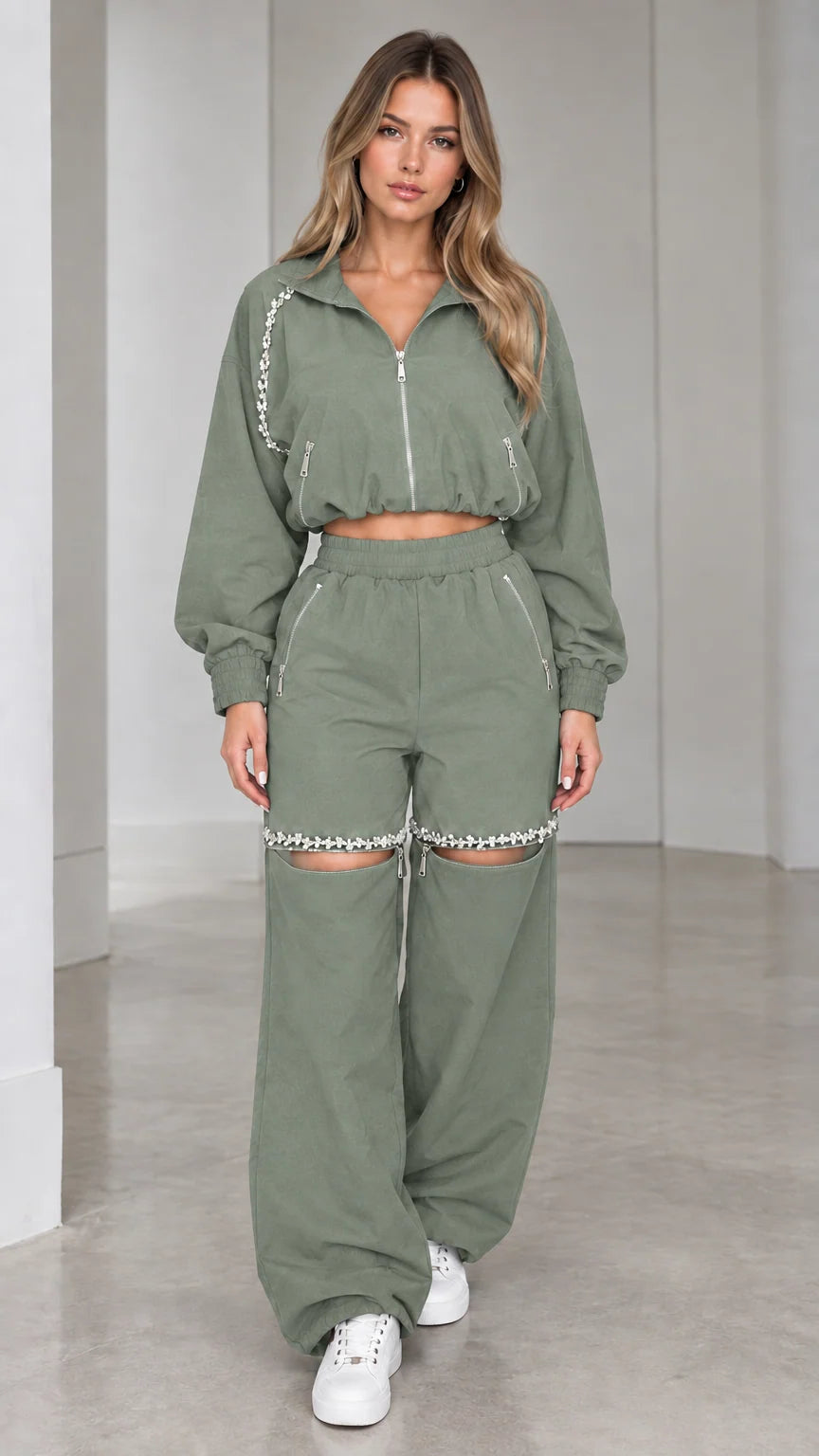 Model wearing sage green cropped zip jacket and rhinestone cut-out wide leg pants set