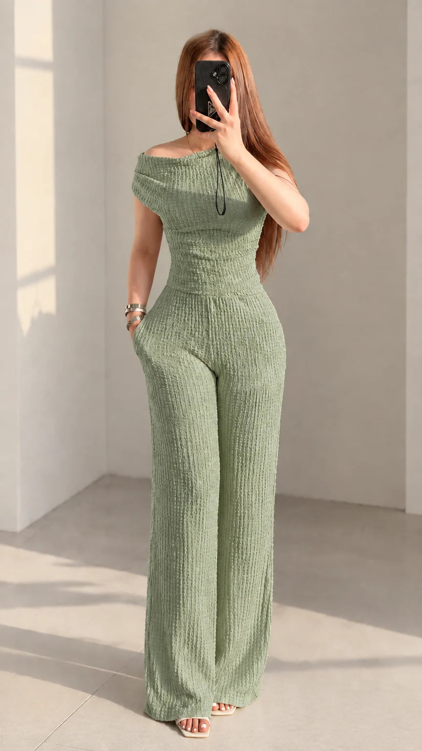 Front view of woman wearing sage green textured off-shoulder matching set