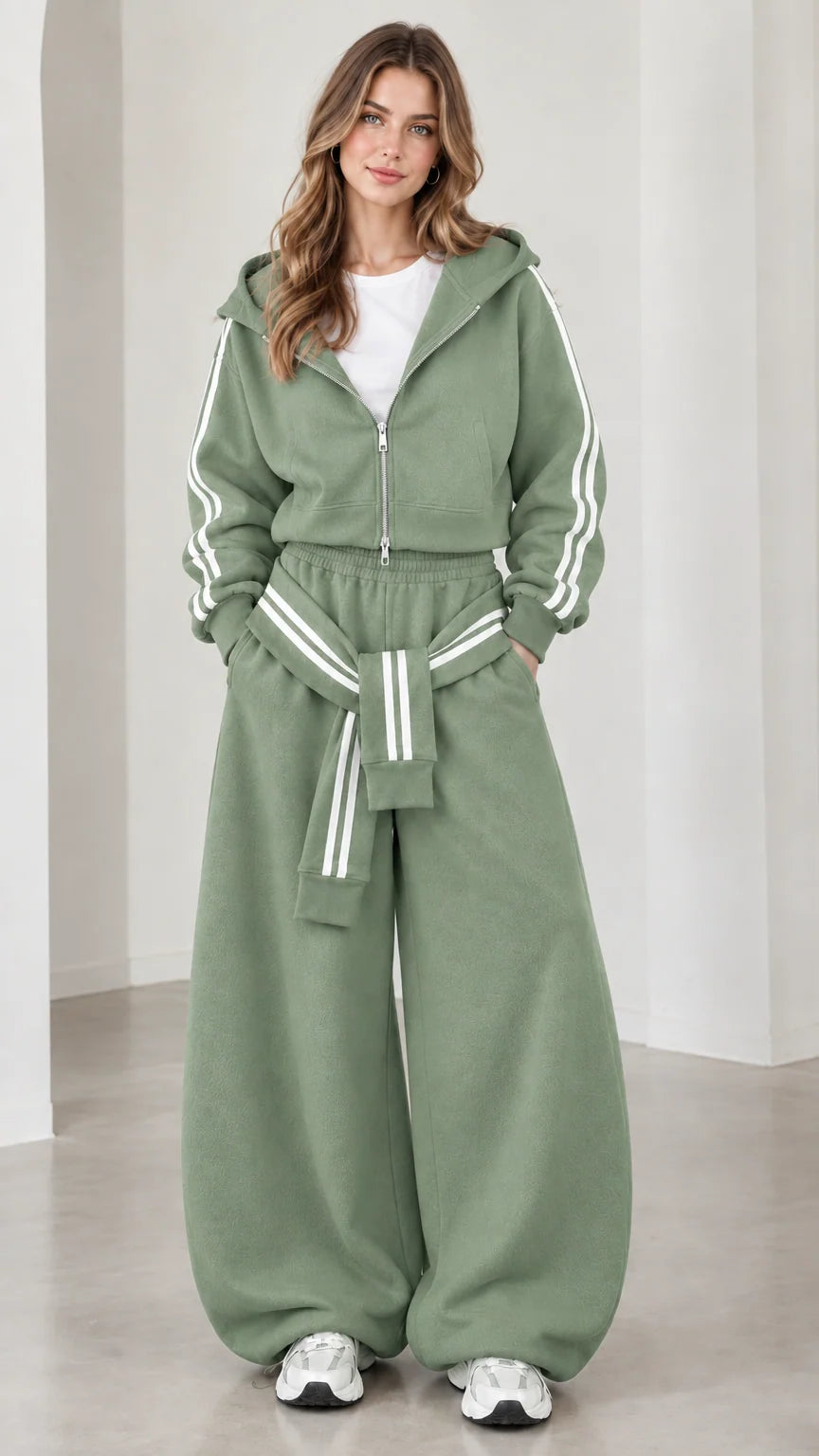 Model wearing sage green cropped hoodie and baggy track pants set